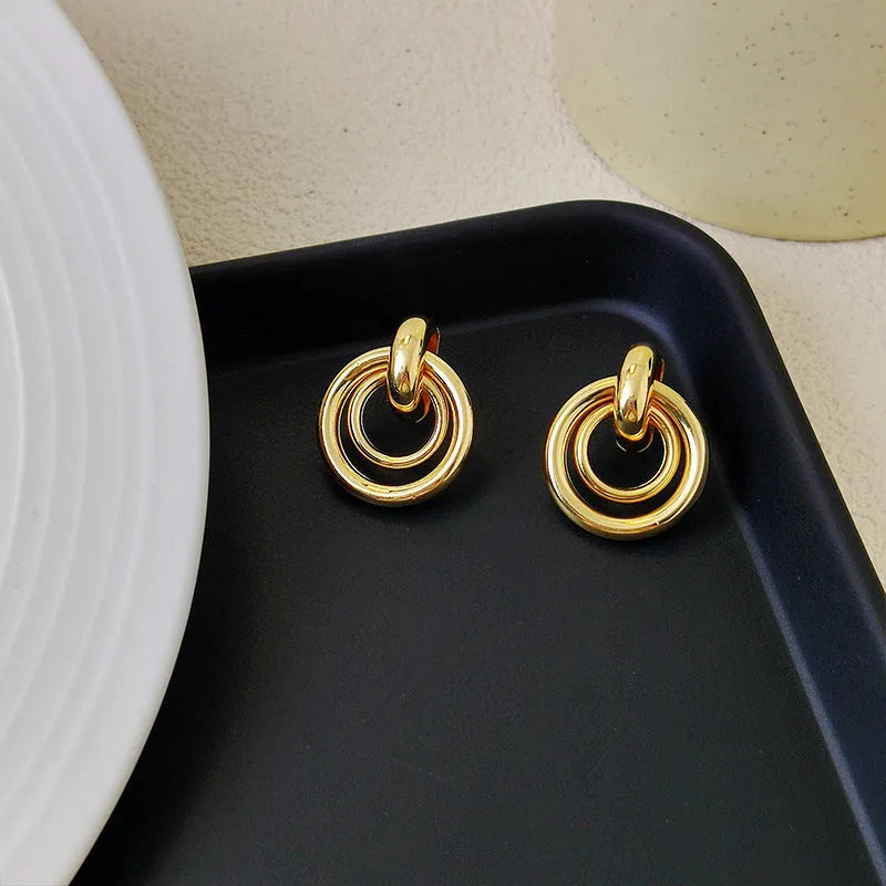 Geometric round ring earrings with irregular design in gold and silver colour options