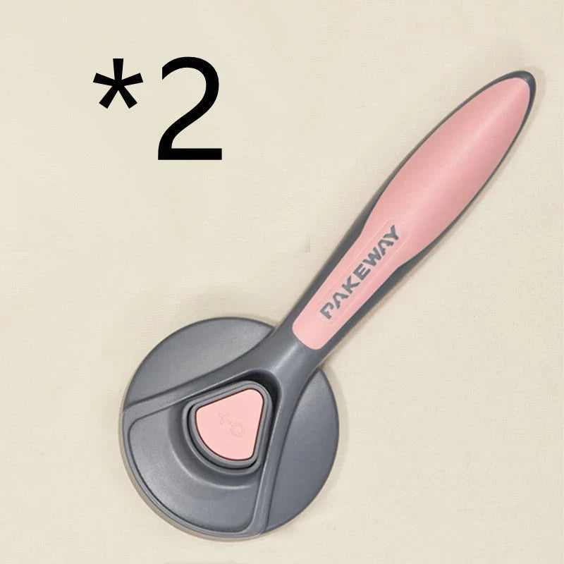 Ergonomic pet grooming brush in mint green, cherry blossom powder, and gentleman grey