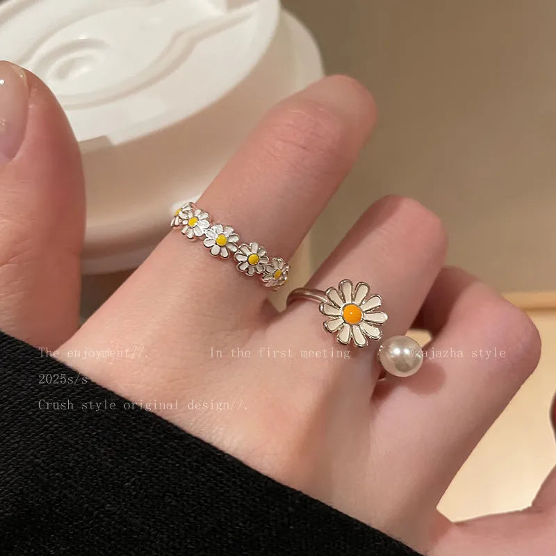 Women's adjustable copper ring set showing little daisy pearl ring and plain daisy ring with opening design.