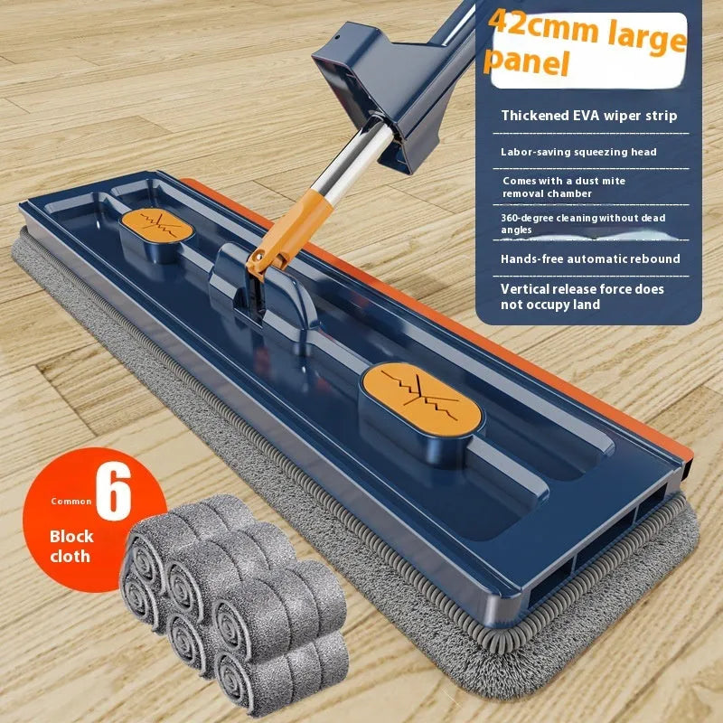 Large flat mop with long stainless steel handle, blue rotating head, and integrated scraper on a hardwood floor.