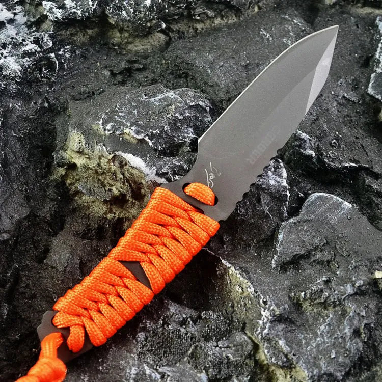 Straight survival knife with rope handle and black ABS sheath on a paper box.