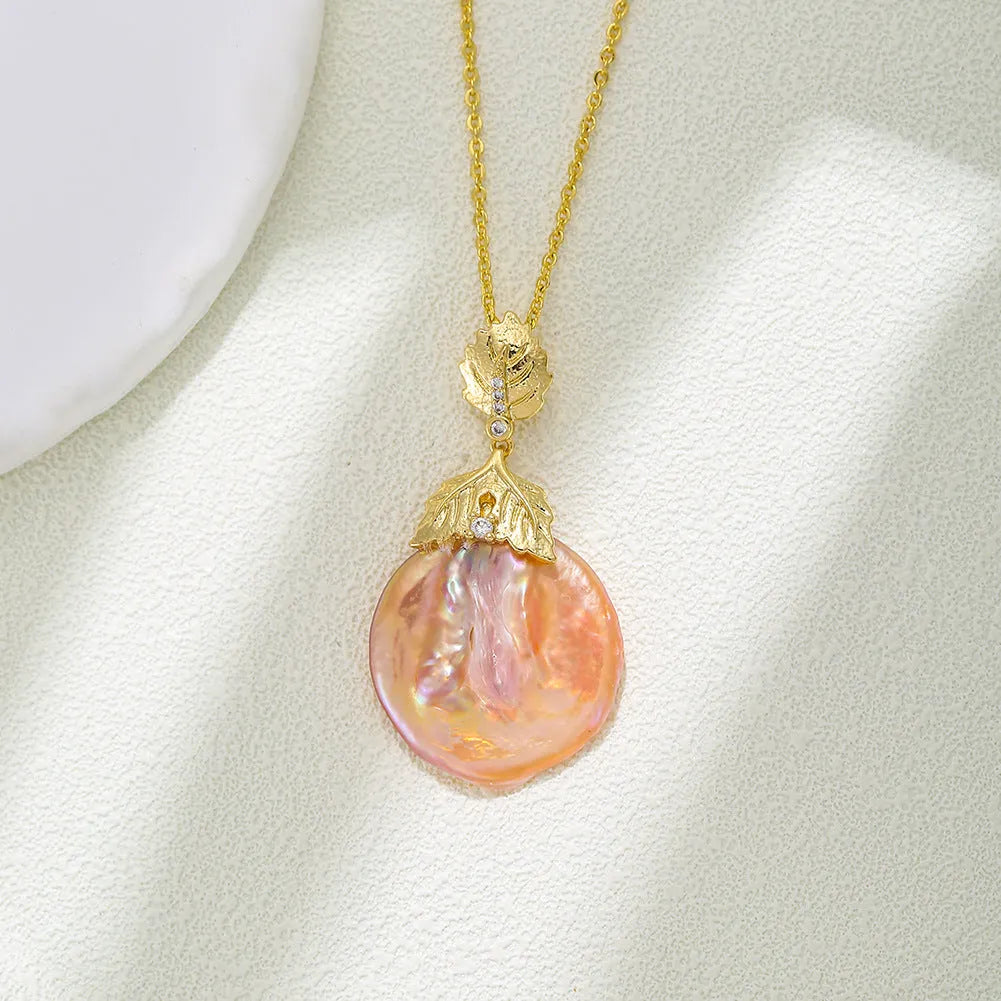 Baroque pendant freshwater pearl necklace clavicle chain with flower leaf motif in Golden Leaves colour, on display