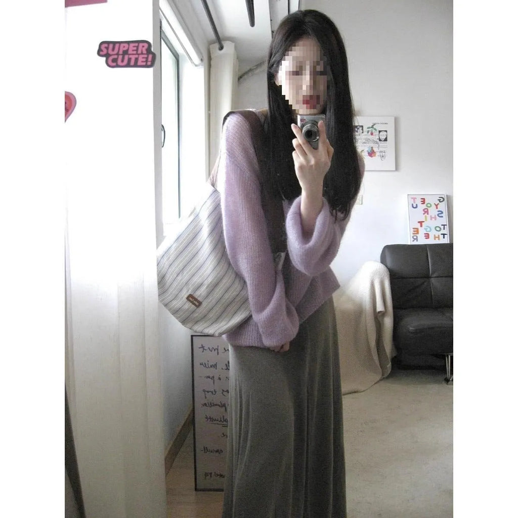 Purple women's sleeveless blouse with hollow out detail and princess sleeves, laid flat.