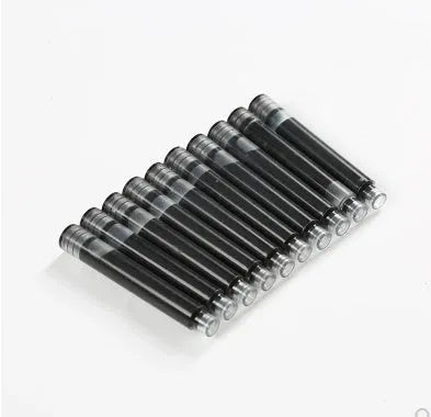 Set of 10 steel ink sac converters for fountain pens next to bottled ink