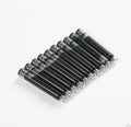 Set of 10 steel ink sac converters for fountain pens next to bottled ink