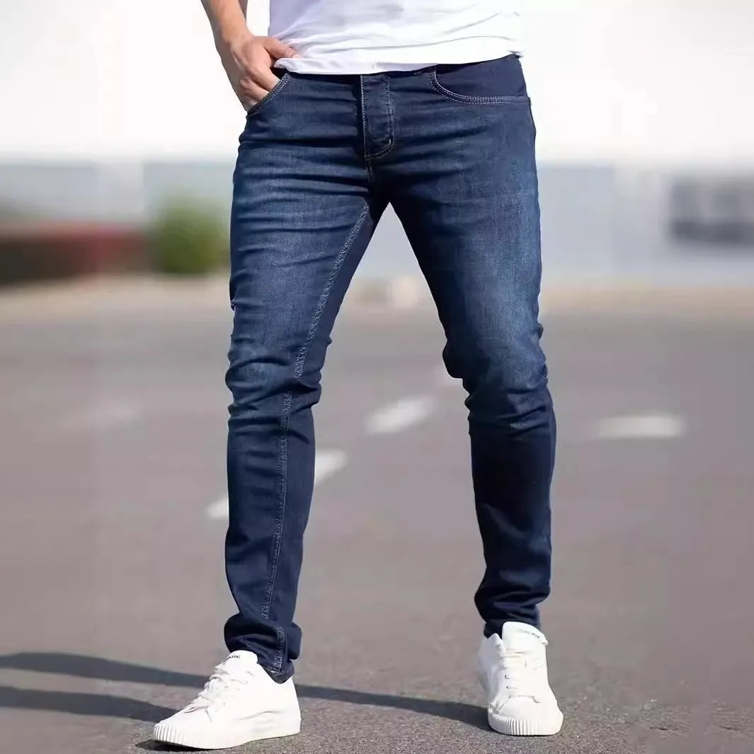 Men's dark blue slim-fit elastic cotton jeans with a skinny leg opening.