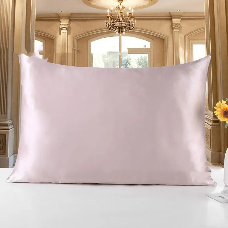 19 M double-sided silk pillowcase shown in one of 14 colours, including apricot, champagne, and navy blue.