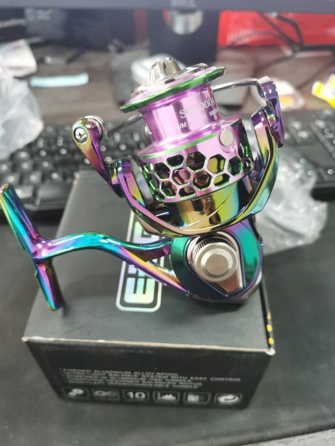 All-metal spinning fishing reel with stainless steel bearings for saltwater use, showing interchangeable handle