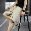 Casual straight-leg loose shorts in green polyester fabric on a neutral background.