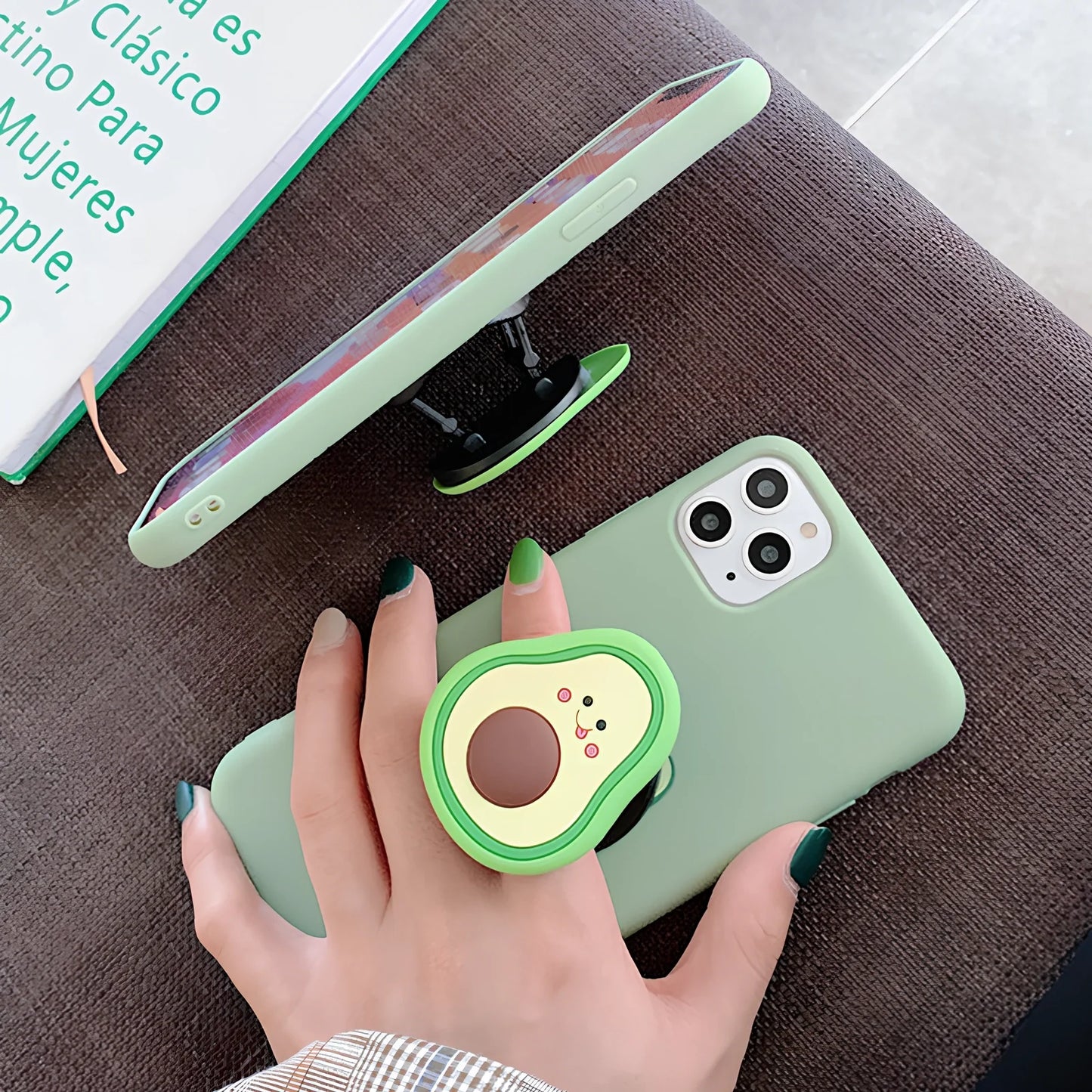 Green avocado pattern silicone iPhone case with metal ring stand attached to back