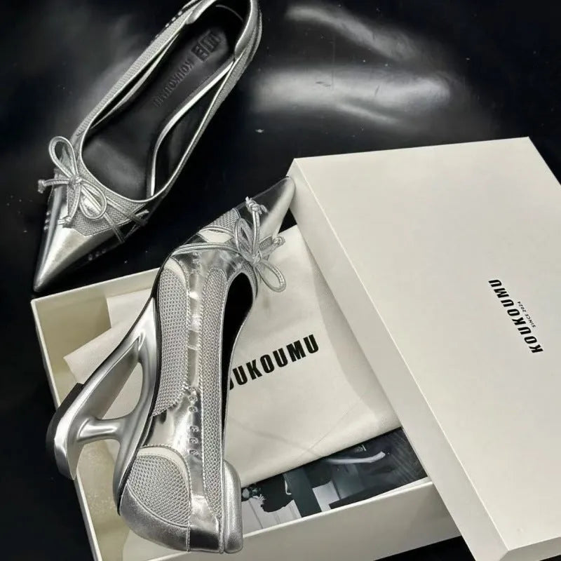 Black women's pointed toe Mary Jane shoes with a floating special-shaped heel on a white background.