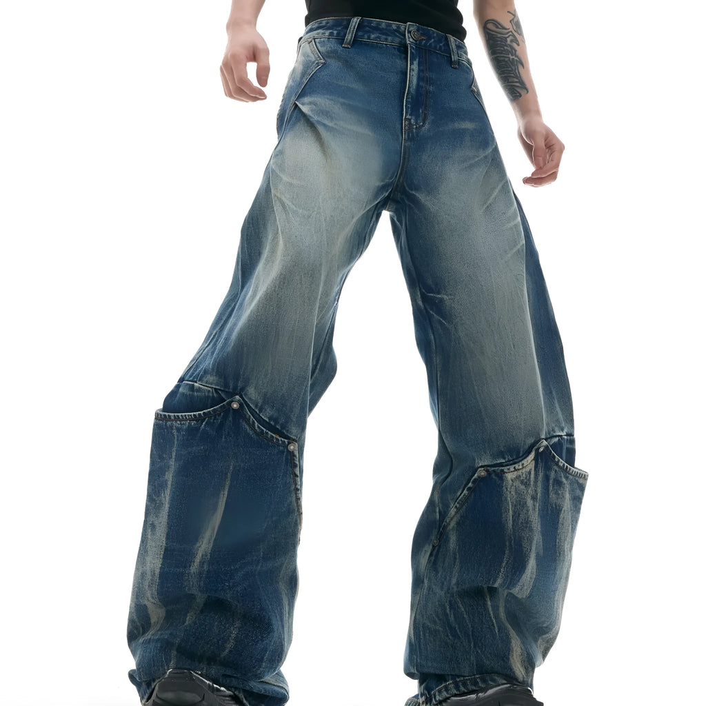 Men's verdant blue loose fit jeans with a washed burst pattern and curved knife leg style.