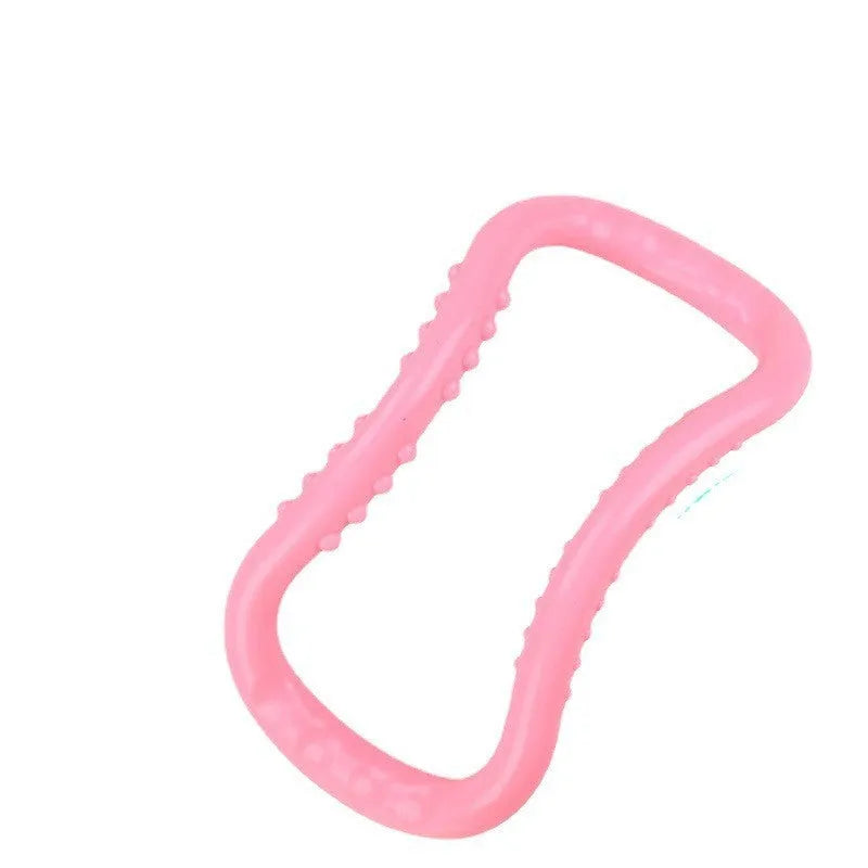A purple yoga stretching ring made of plastic on a plain background.