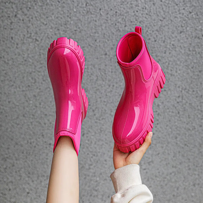 PVC low tube rain boot in solid colour with flat heel and non-slip sole.