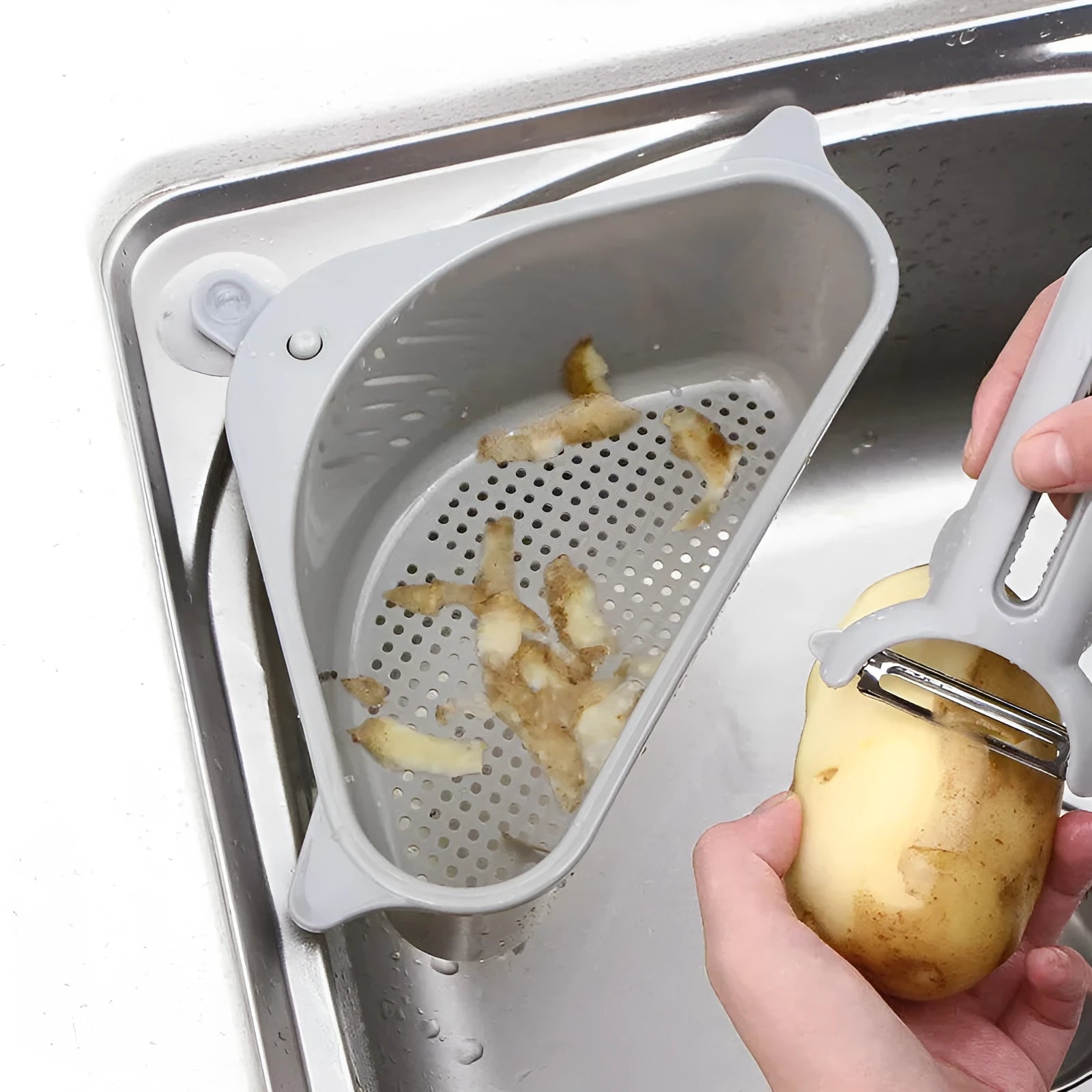 Beige plastic triangle sink storage rack for draining sponges, shown mounted on a kitchen faucet.