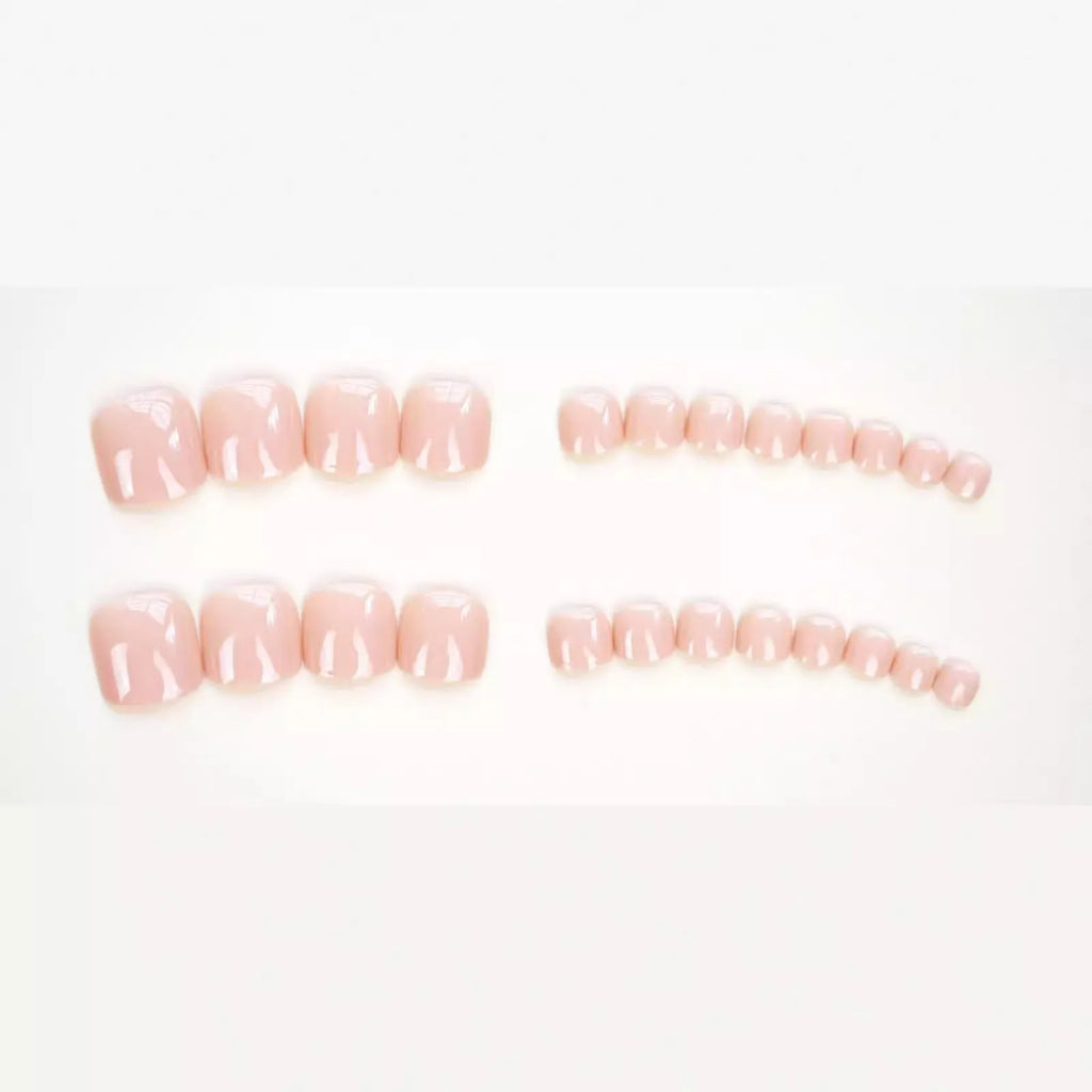Finished plastic toenail stickers in skin colour with glue bottle, presented on a card.