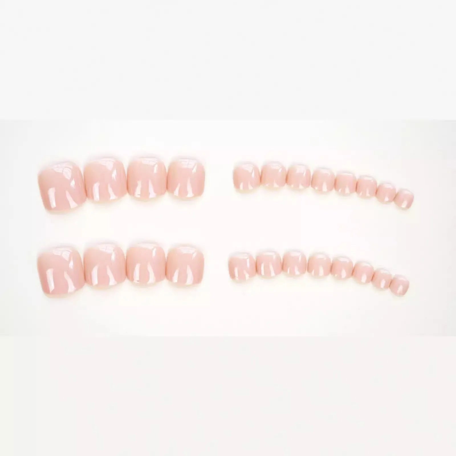 Finished plastic toenail stickers in skin colour with glue bottle, presented on a card.