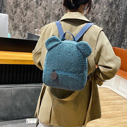 Cute, bear-shaped backpack made of soft, fleece material in various colors for casual travel and daily use