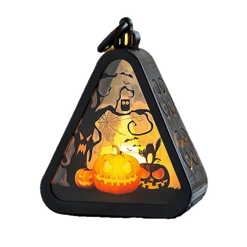 Portable Halloween pumpkin lamp decoration in choice of four colours on a table.