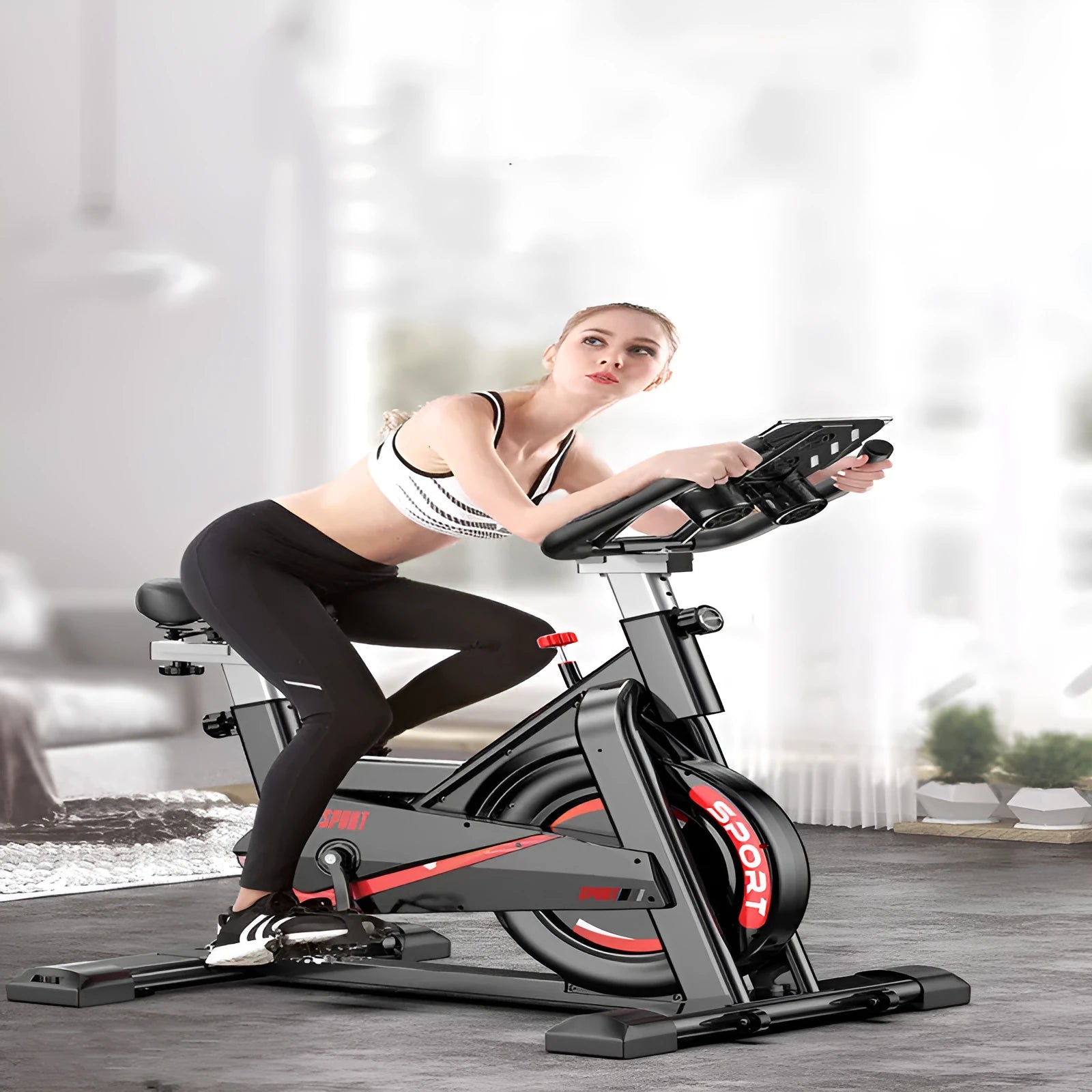 Black upright spinning bike with padded saddle and handlebars for home fitness