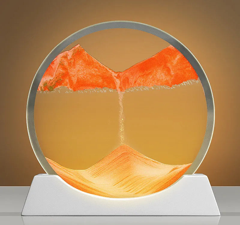 Creative quicksand painting rotary night lamp on a desk, showing abstract colours inside a 12-inch glass cylinder.