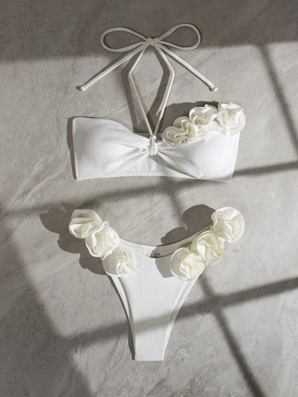 White halter neck bikini set with 3D flower design and lace-up back