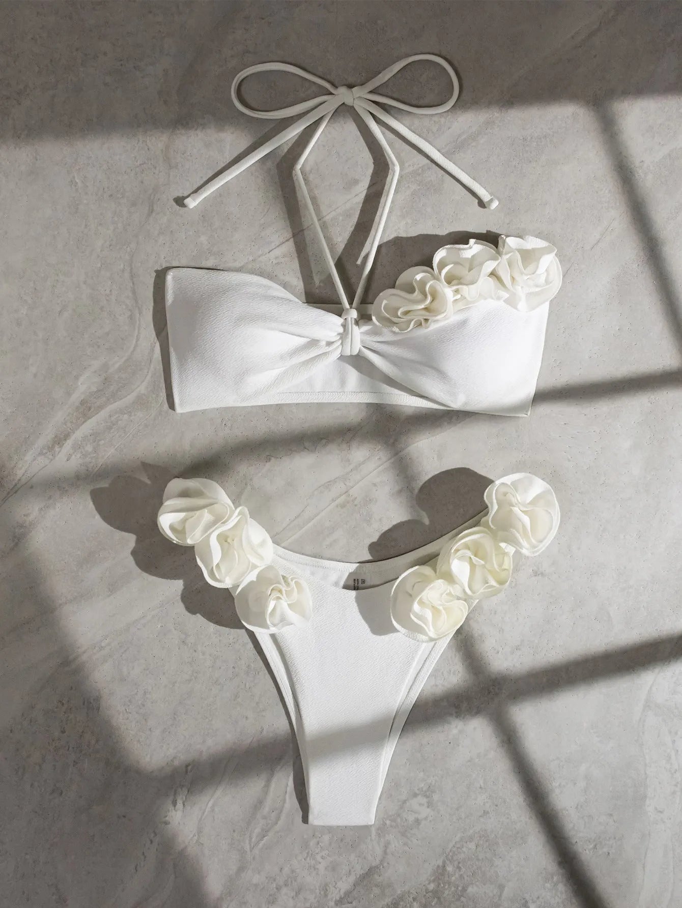 White halter neck bikini set with 3D flower design and lace-up back