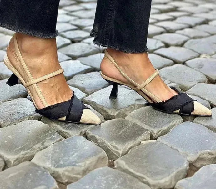 Apricot and black women's stiletto heel sandals with pointed toe and buckle fastening.