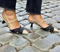 Apricot and black women's stiletto heel sandals with pointed toe and buckle fastening.
