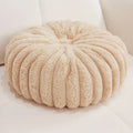 Pumpkin shaped seat cushion in khaki with short plush cover, 35x35x15cm, next to a window