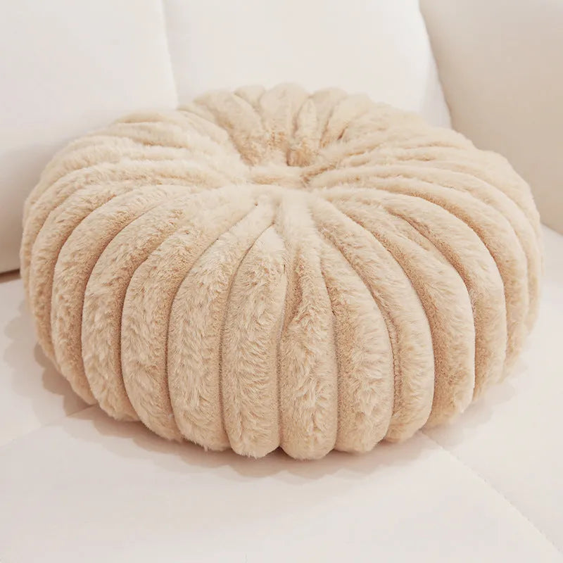 Pumpkin shaped seat cushion in khaki with short plush cover, 35x35x15cm, next to a window