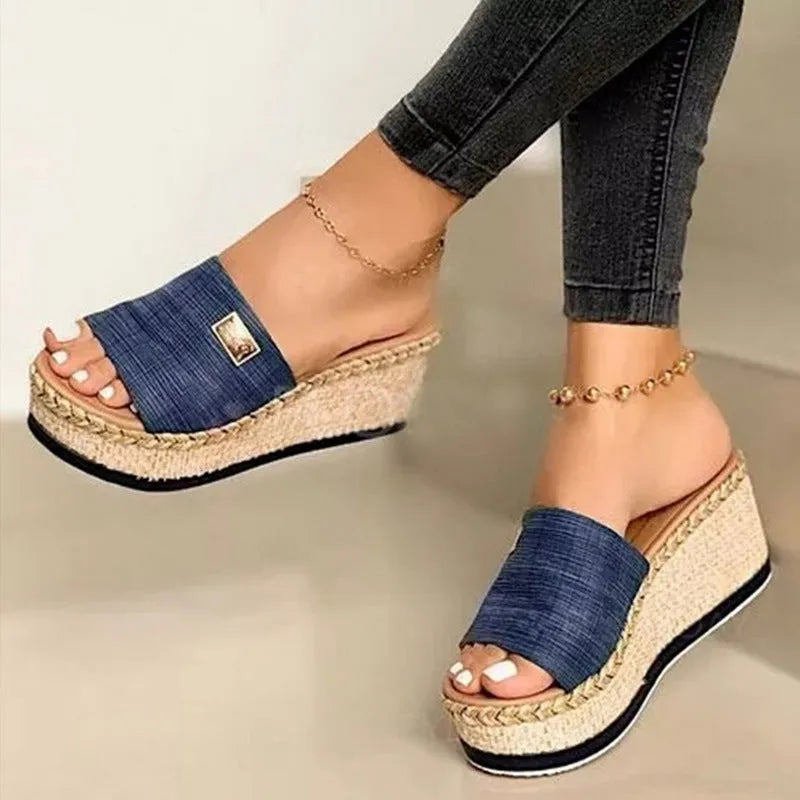 Platform wedge heel sandals with cloth upper in black, side view showing plain pattern and metal element detail
