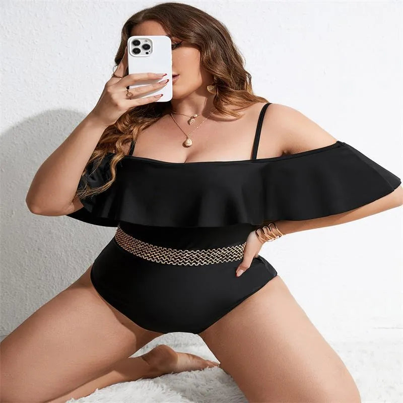 Black women's one-piece swimsuit on hanger, plus size range 0XL to 4XL.