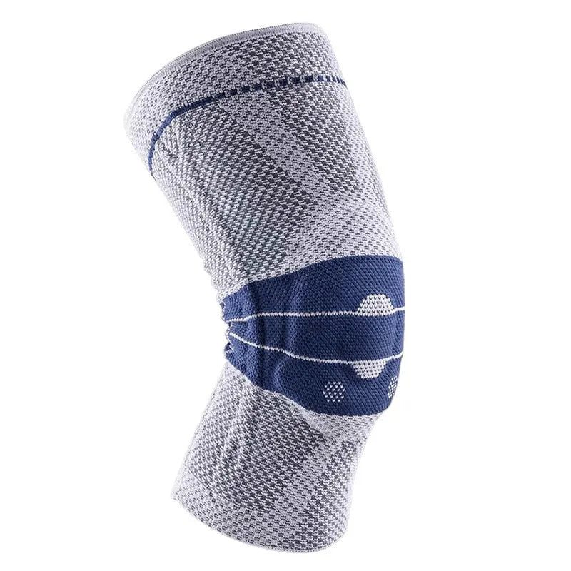 A pair of adult sports knee pads in a black and blue colourway, shown on a knee for scale.