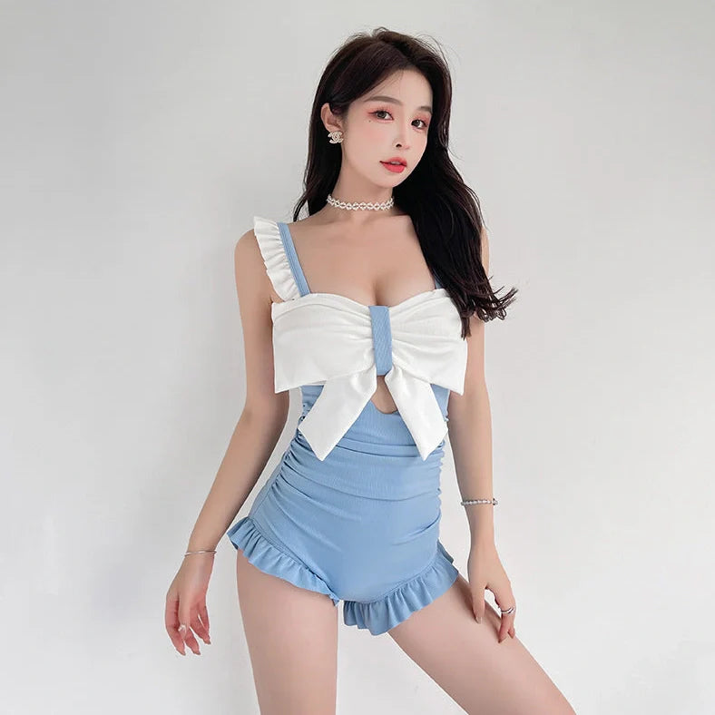 Women's one-piece swimsuit with adjustable bow detailing in solid colour