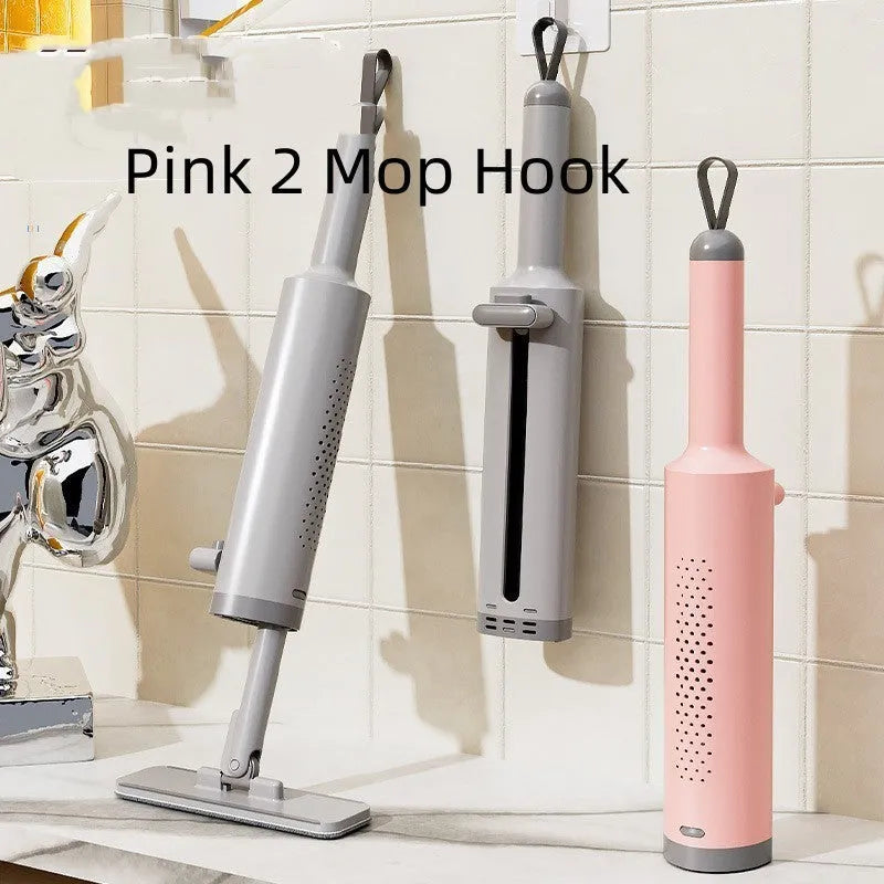 Pink self-squeezing flat mop with rotatable head and microfiber pads for floor cleaning