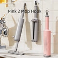 Pink self-squeezing flat mop with rotatable head and microfiber pads for floor cleaning