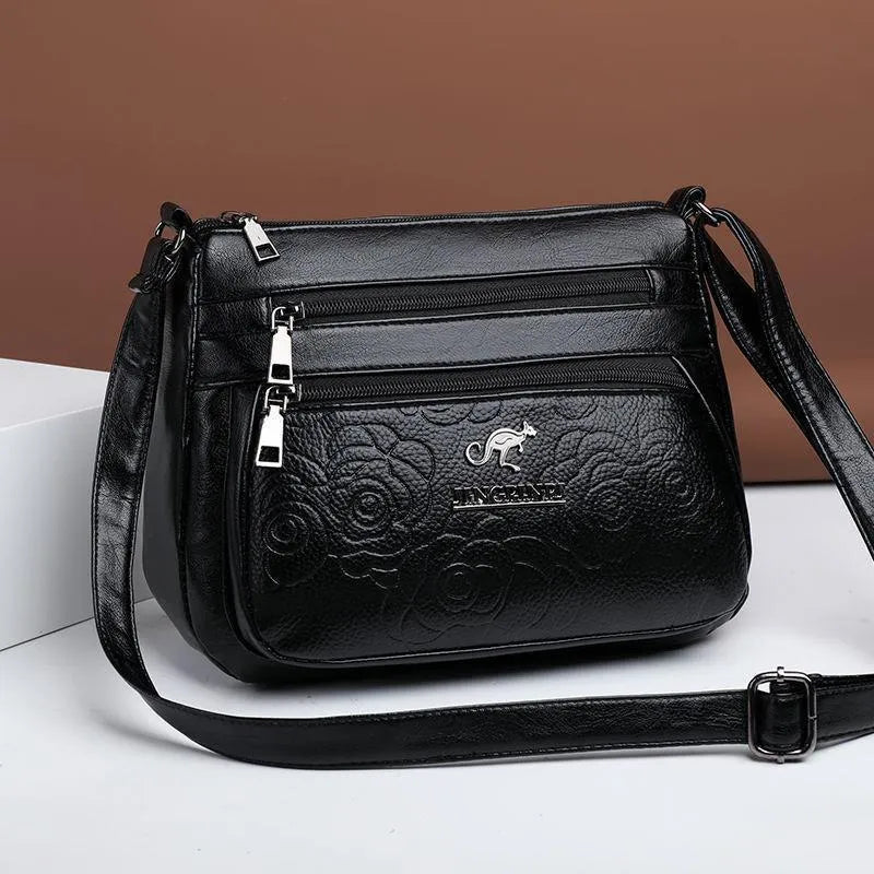 Women's black PU leather messenger bag with embossing and sewing thread details, horizontal square shape, single shoulder strap