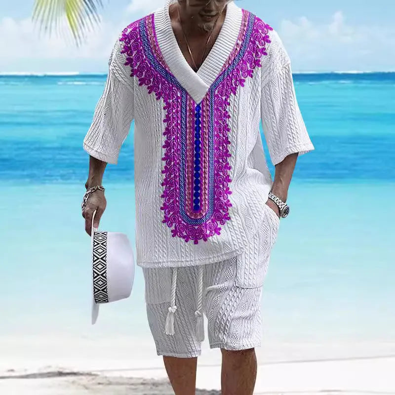 Man wearing a solid colour knitted short-sleeved top and matching shorts, showing the drop-shoulder design.