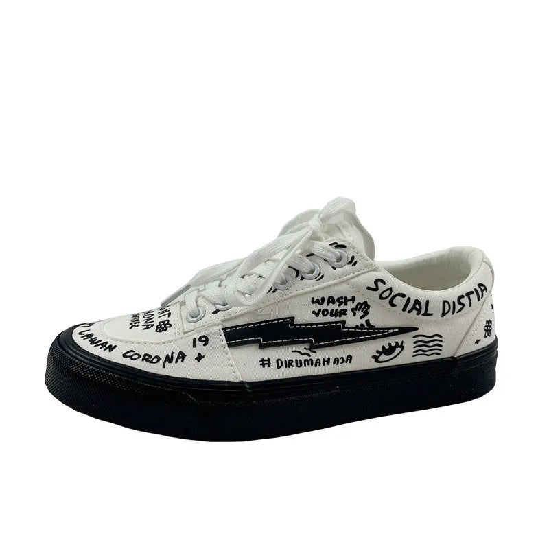 Women's white canvas shoes low top with lace-up tie and graffiti pattern on non-slip vulcanised sole