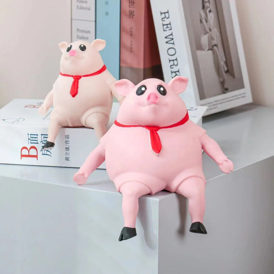 Piggy-shaped stress relief toys made from soft, eco-friendly rubber with cute scarf accents