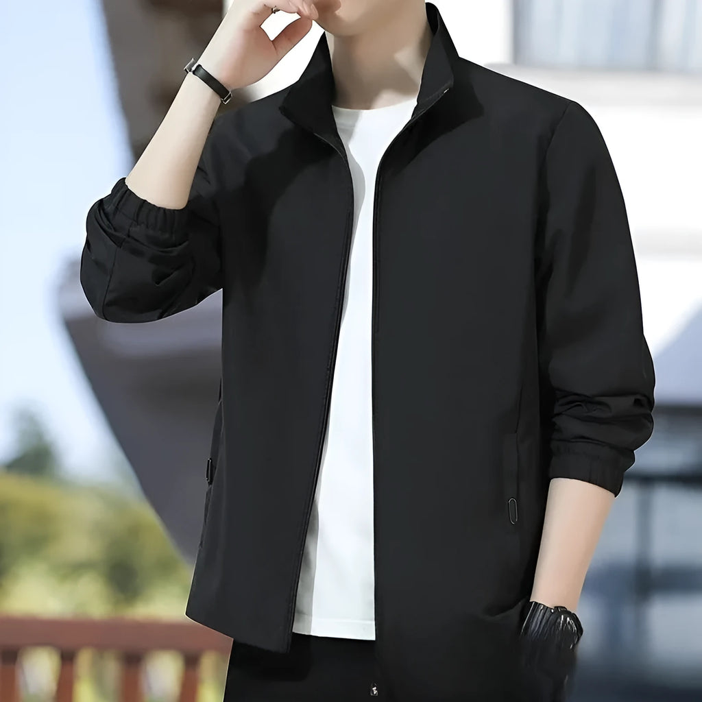 Man wearing a loose-fit black lapel collar casual jacket, Korean style, with zippered pockets.
