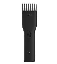 Black cordless electric hair clipper with adjustable comb and ceramic cutter head on a white background