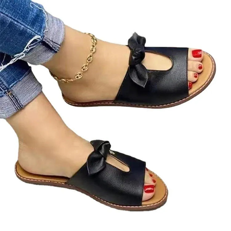 Ladies casual sandals with fish mouth design and a bow on the upper, in black, pink, or gold.