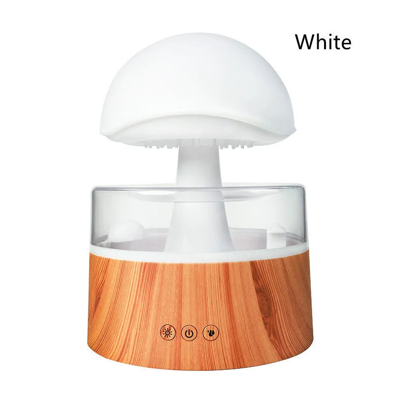 White rain cloud shaped ultrasonic humidifier and aromatherapy diffuser with coloured lights on a wooden table.