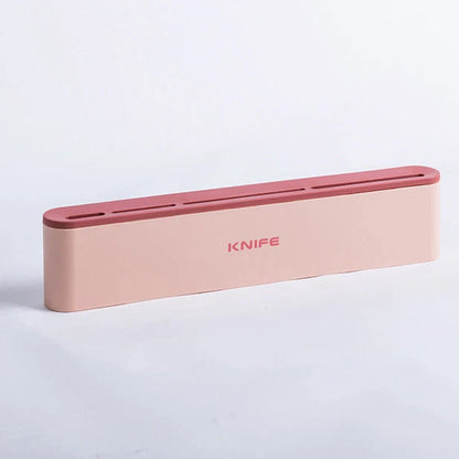 Wall-mounted kitchen knife holder in grey, pink, and light blue