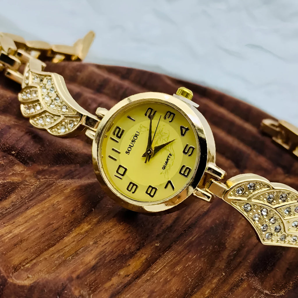 Stainless steel women's watch with round dial on a metal strap with Vachette clasp, shown in gold colour.