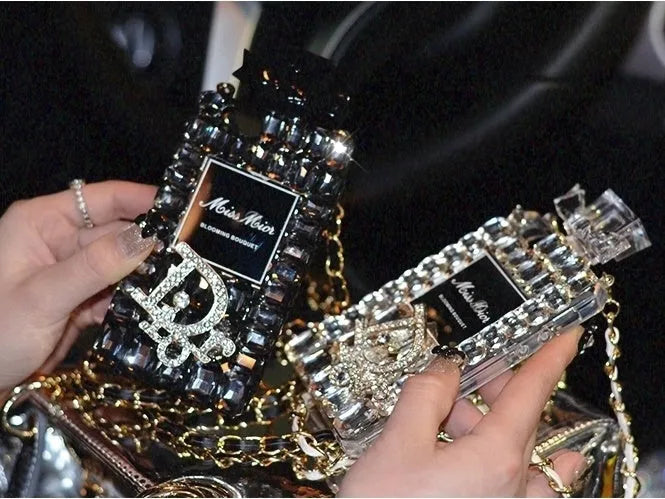 iPhone case with perfume bottle bow design, TPU silicone construction, and attached metal chain