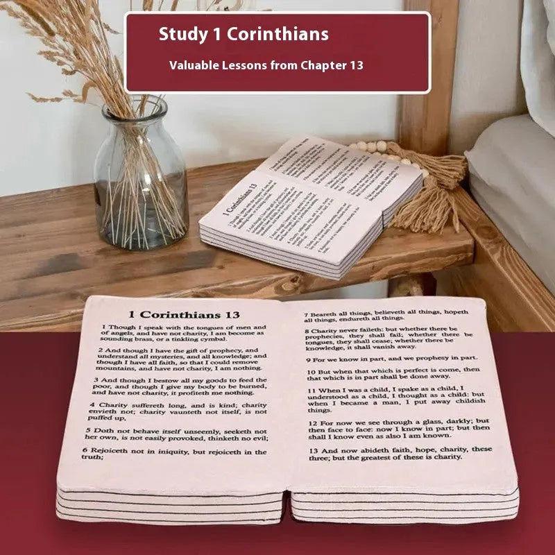 Solid-colour Christmas bible plush toy doll pillow on a chair.