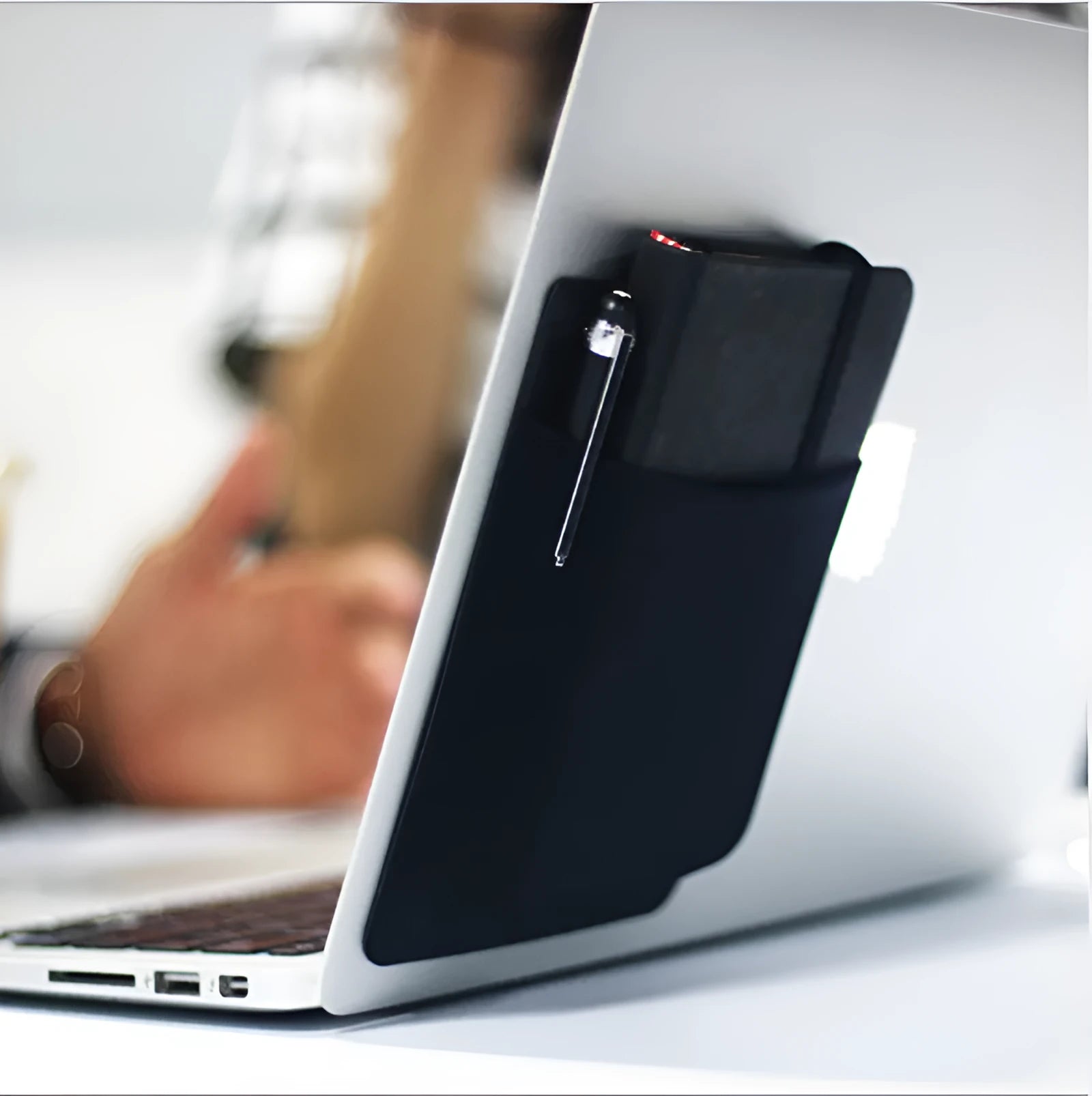 Black adhesive laptop back storage bag with pen loop, 15x12cm, stuck to laptop back